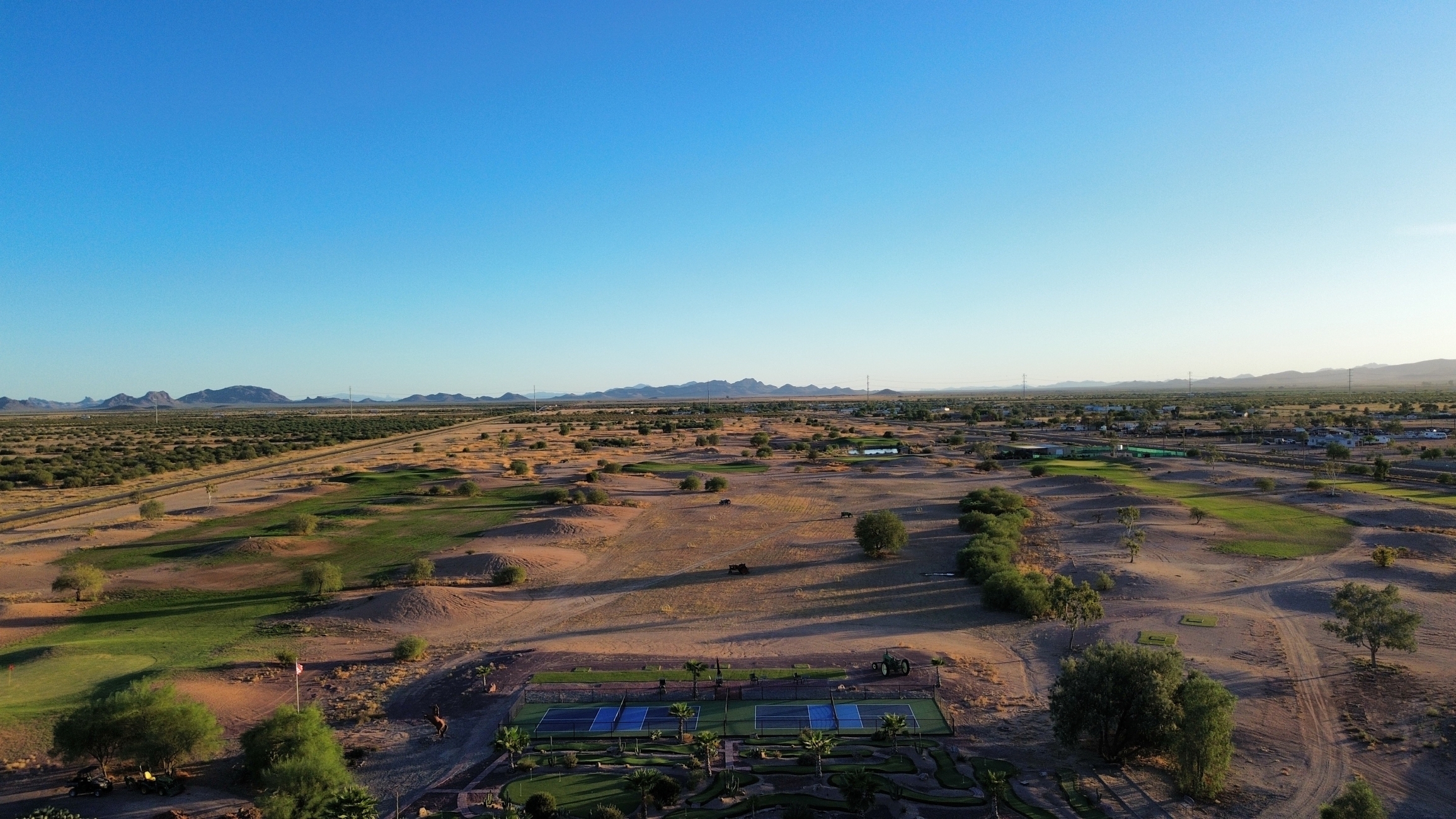 Image of golf ball on tee on grass.